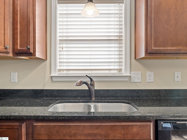 kitchen featuring sink, hanging light fixtures, dark stone counters, and dishwasher