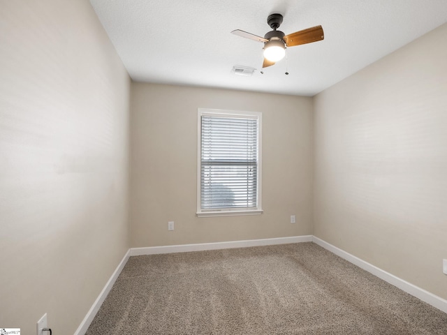 carpeted spare room with ceiling fan