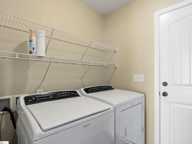 washroom featuring washer and clothes dryer