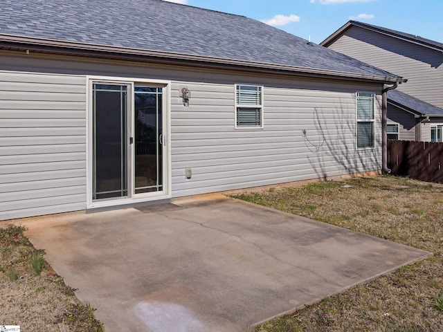 rear view of property featuring a lawn and a patio area