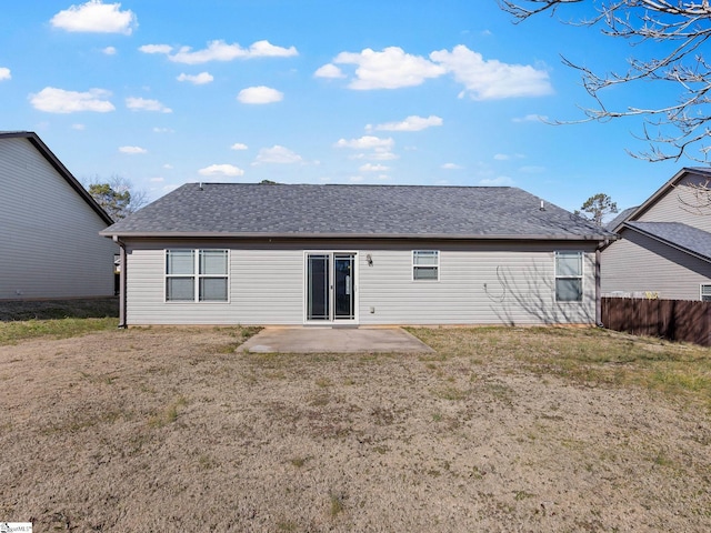 rear view of house featuring a yard and a patio area