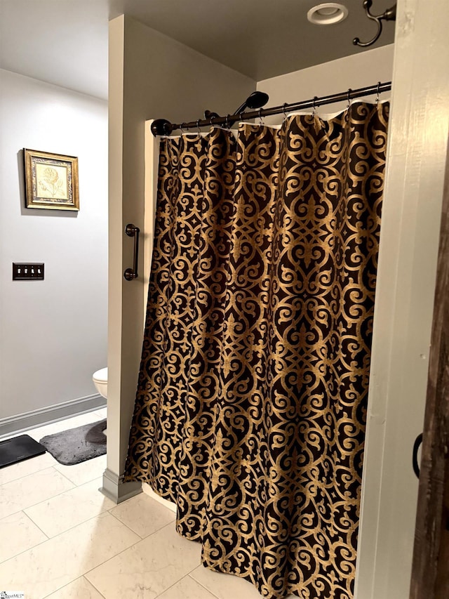 bathroom featuring toilet and a shower with shower curtain