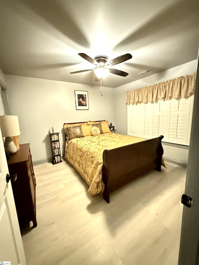 bedroom featuring light hardwood / wood-style flooring and ceiling fan