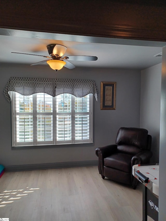 living area featuring ceiling fan and light wood-type flooring