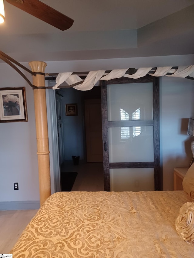 unfurnished bedroom featuring wood-type flooring and ceiling fan