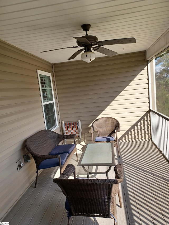 wooden deck featuring an outdoor hangout area and ceiling fan