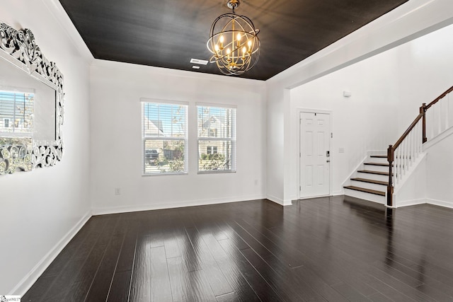 foyer entrance featuring dark hardwood / wood-style floors, a healthy amount of sunlight, and an inviting chandelier