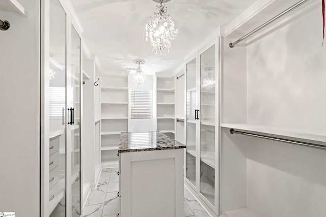 walk in closet featuring an inviting chandelier