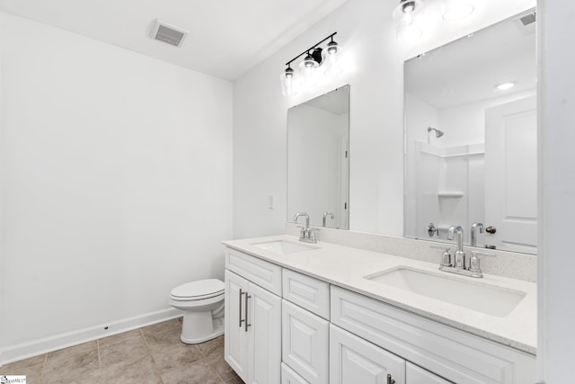 bathroom with vanity, a shower, tile patterned floors, and toilet