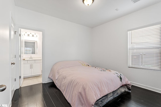 bedroom with sink, hardwood / wood-style flooring, and ensuite bath