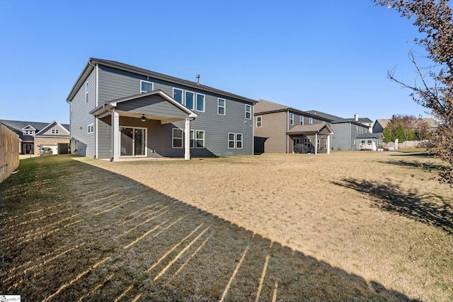 rear view of property with a yard