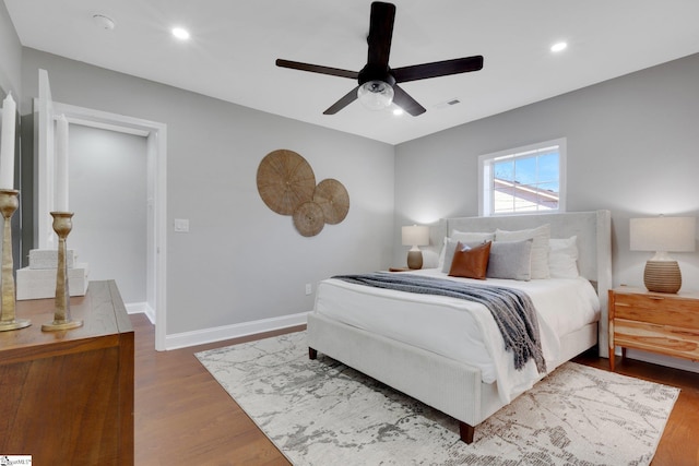 bedroom with hardwood / wood-style floors and ceiling fan