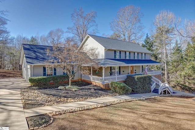 farmhouse-style home with a front lawn and covered porch