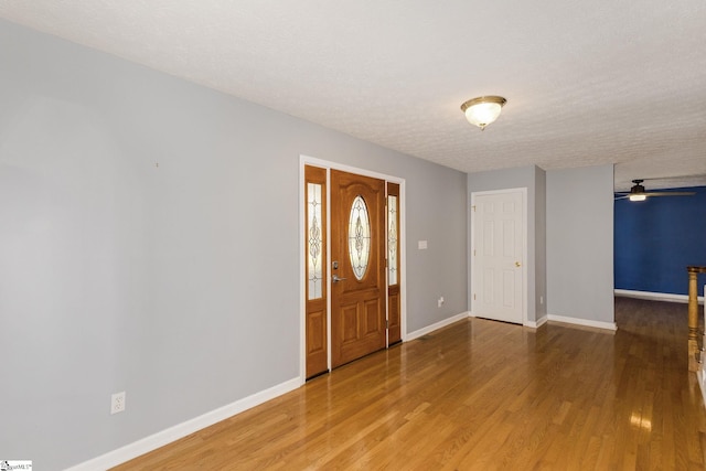 foyer entrance with hardwood / wood-style flooring and a textured ceiling