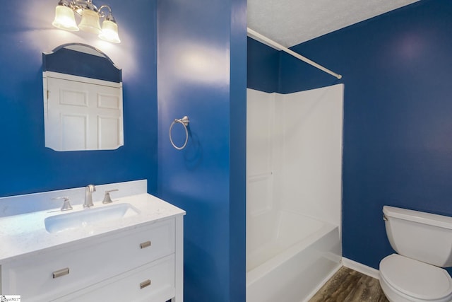 full bathroom featuring toilet, bathing tub / shower combination, wood-type flooring, a chandelier, and a textured ceiling