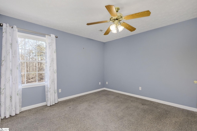 carpeted spare room with ceiling fan