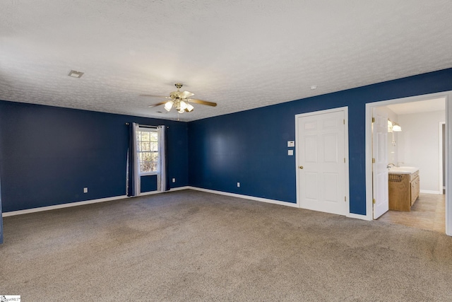 spare room with light carpet, a textured ceiling, and ceiling fan