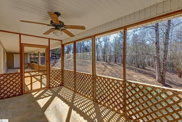 unfurnished sunroom with ceiling fan