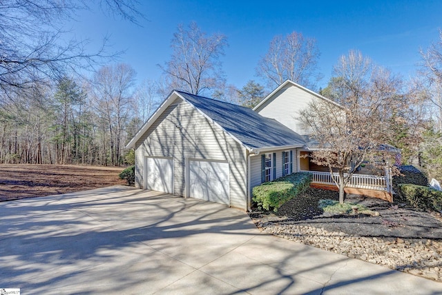 view of side of home with a porch and a garage