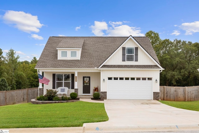 craftsman-style house featuring a garage and a front yard