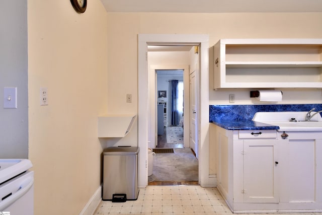 kitchen with white cabinetry and sink