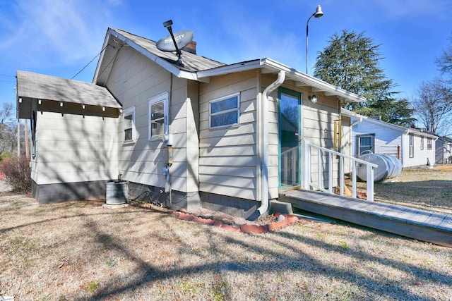 view of property exterior with a yard