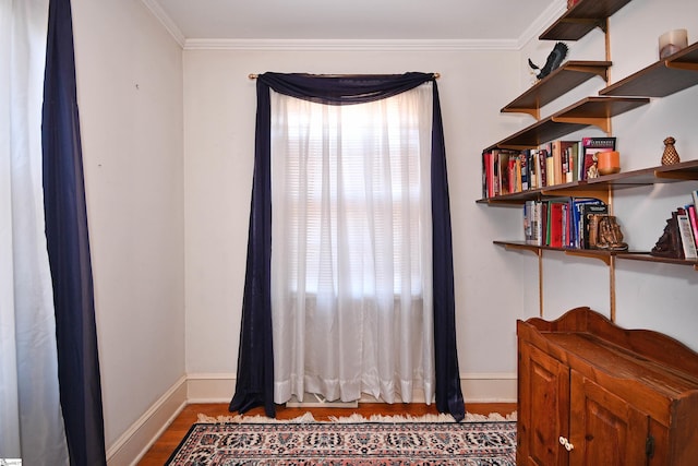 interior space featuring hardwood / wood-style floors and crown molding