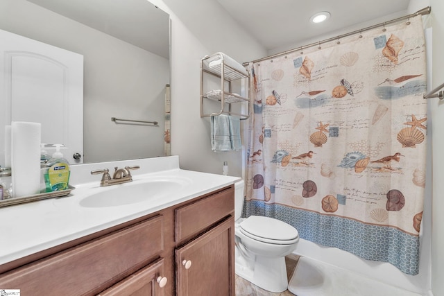 bathroom featuring vanity, walk in shower, and toilet