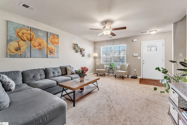 carpeted living room featuring ceiling fan