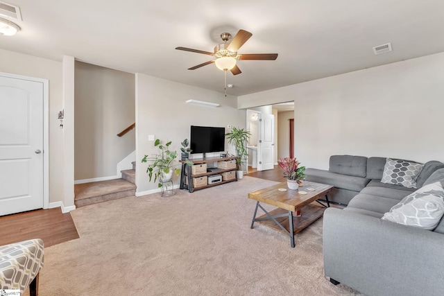 living room with ceiling fan and light colored carpet