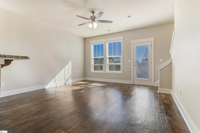 spare room featuring ceiling fan and dark hardwood / wood-style floors