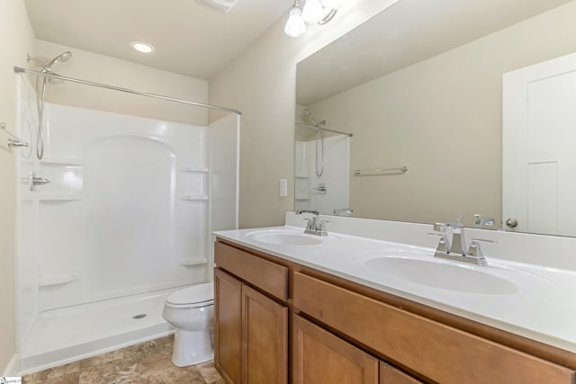 bathroom with vanity, toilet, and walk in shower