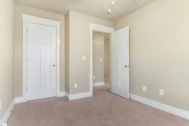 unfurnished bedroom featuring light carpet