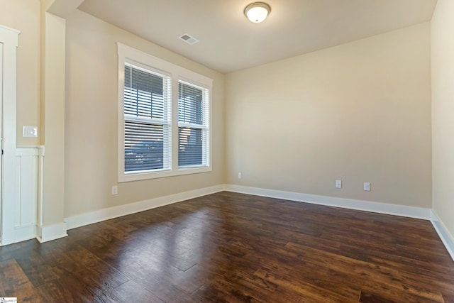 spare room with dark hardwood / wood-style flooring