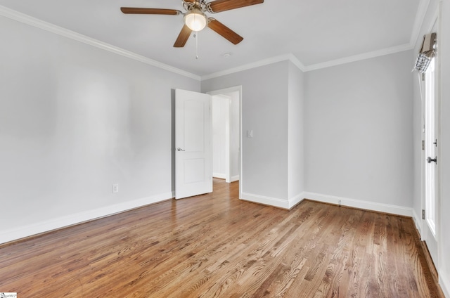 spare room featuring ornamental molding, ceiling fan, and light hardwood / wood-style flooring