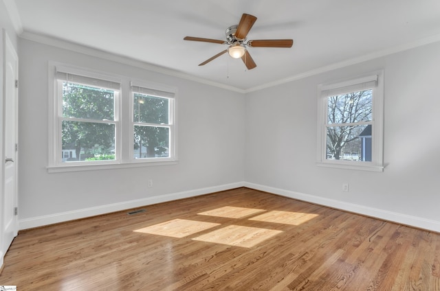 spare room featuring crown molding, ceiling fan, and light hardwood / wood-style floors