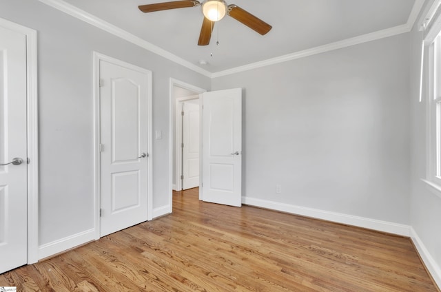 unfurnished bedroom featuring ornamental molding, ceiling fan, and light wood-type flooring