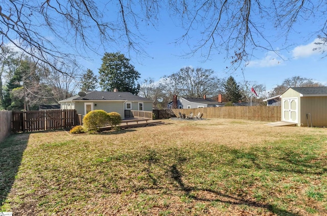 view of yard with a wooden deck and a storage unit