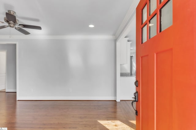 entrance foyer with ornamental molding, ceiling fan, and dark hardwood / wood-style flooring