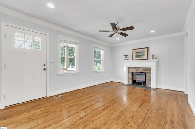 unfurnished living room featuring crown molding, light hardwood / wood-style floors, and ceiling fan