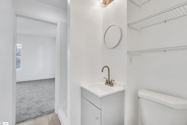 bathroom featuring vanity and toilet