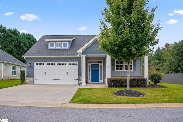 view of front facade featuring a garage and a front lawn