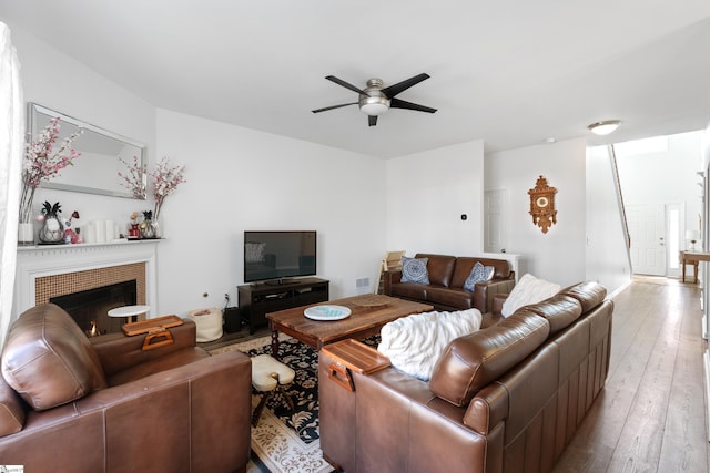 living room featuring ceiling fan and light hardwood / wood-style floors