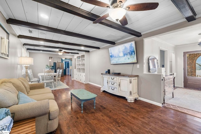 living room featuring ornamental molding, built in features, beamed ceiling, ceiling fan, and hardwood / wood-style floors