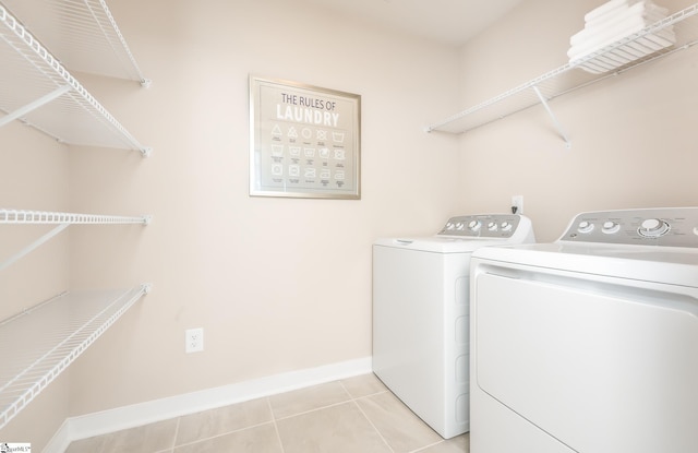 laundry area featuring light tile patterned flooring and washer and dryer