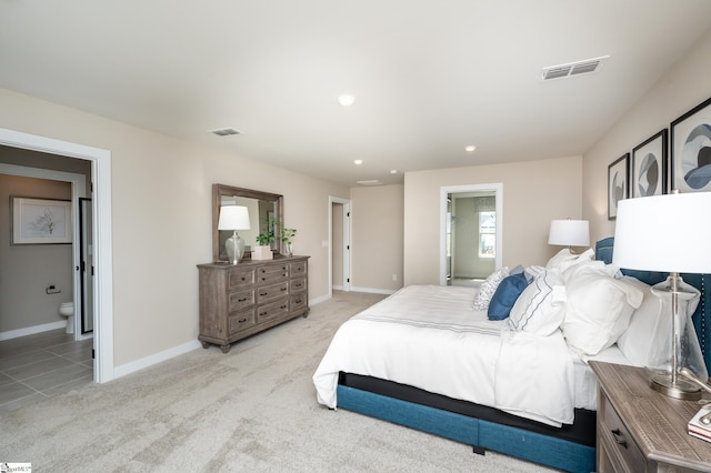 carpeted bedroom with ensuite bath