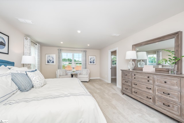 carpeted bedroom with multiple windows