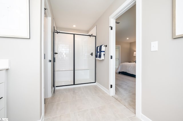 bathroom featuring a shower with shower door and tile patterned floors