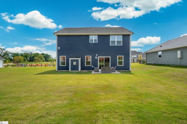 rear view of house featuring a patio area and a lawn