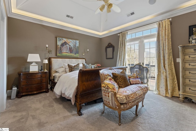 carpeted bedroom with ceiling fan, ornamental molding, and a tray ceiling